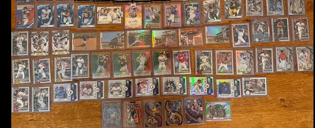 A seller's own photo of the baseball card collection they sent in, laid out on a table.